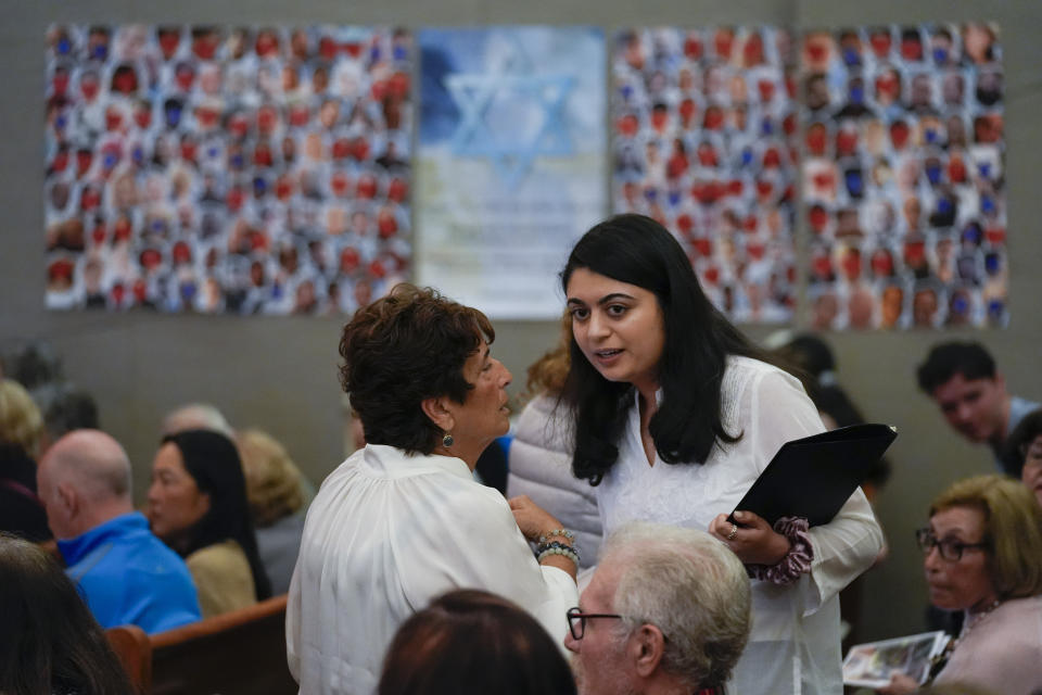 Writer Lulu Fairman, left, talks with writer and co-producer Maryam Chishti before a performance of "What Do I Do With All This Heritage?" on Wednesday, May 22, 2024, in Los Angeles. The show offers more than 14 true stories of Asian American Jews. (AP Photo/Ashley Landis)