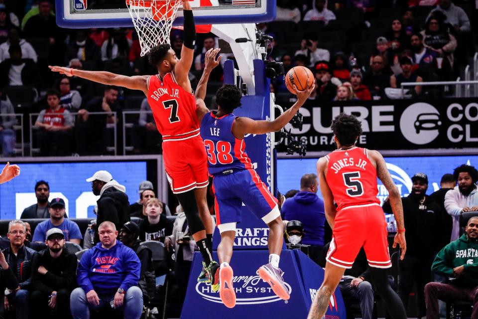 Detroit Pistons guard Saben Lee (38) makes a layup against Chicago Bulls forward Troy Brown Jr. (7) during the first half at the Little Caesars Arena in Detroit on Wednesday, March 9, 2022.