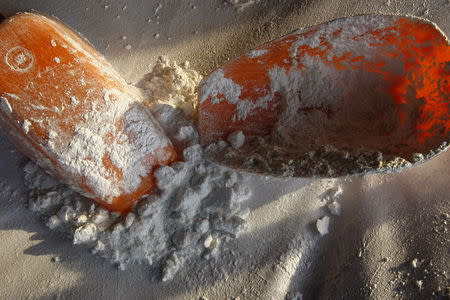 Sodium hydroxide and plastic spoons are seen at a clandestine laboratory for drug processing in Zacoalco de Torres, Mexico, in this May 24, 2011 file photo. REUTERS/Alejandro Acosta/Files