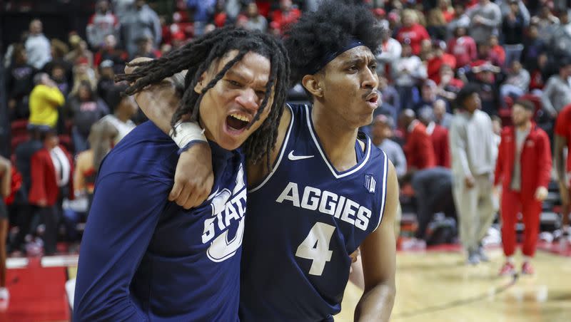 Utah State guards Garrison Phelps (2) and Ian Martinez (4) react after their 87-86 win against UNLV during an NCAA college basketball game on Saturday, Jan. 13, 2024, in Las Vegas.