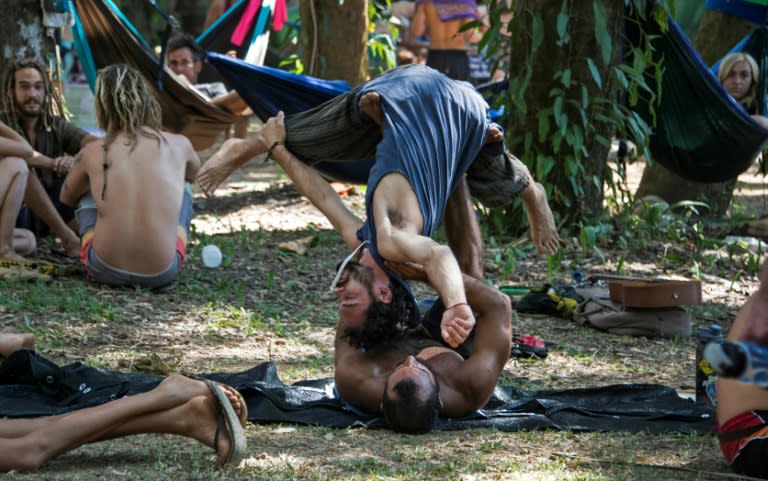 Men practice Acroyoga during the Envision Festival in Puntarenas, Costa Rica, on February 24, 2017