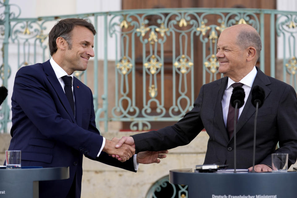 FILE - German Chancellor Olaf Scholz, right, and French President Emmanuel Macron shake hands during a press conference at the German government guest house in Meseberg, north of Berlin, Germany, on May 28, 2024. The German government has expressed concern about a possible victory of the far-right National Rally in France. Chancellor Scholz and many ordinary Germans fears that if the the nationalist French party gets elected on Sunday, it would no longer support the close and unique relationship between the two countries that was carefully built over decades since the end of World War II.(AP Photo/Ebrahim Noroozi)