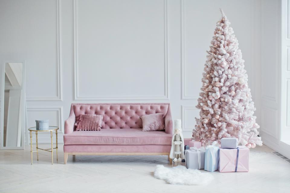 A pink sofa and pink Christmas tree.
