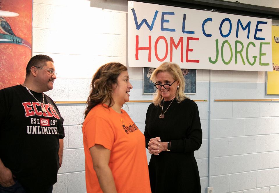 Jorge Garcia, 41, left, listens as his wife Cindy Garcia, 47 sparks before a press conference was held with Rep. Debbie Dingell, D-Dearborn, to welcome once deported Jorge Garcia back to the U.S. and his family at the Lincoln Park Library Friday, Jan. 10, 2020.