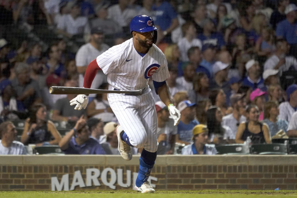 Making his Major League debut, Chicago Cubs' Narciso Crook tosses his bat aside and watches his RBI double during the seventh inning of a baseball game against the Cincinnati Reds Thursday, June 30, 2022, in Chicago. (AP Photo/Charles Rex Arbogast)