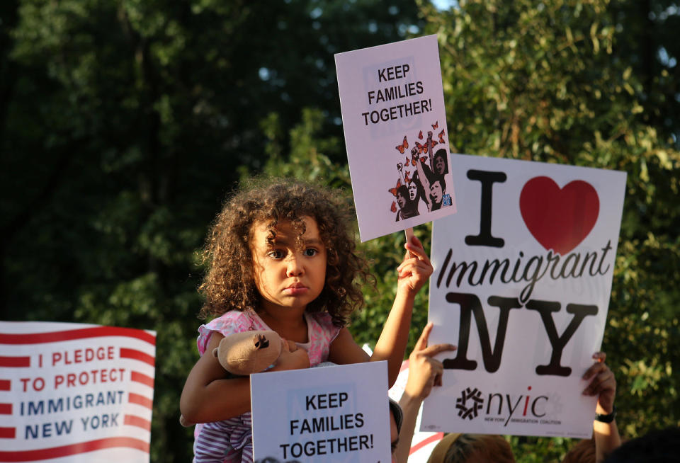 A girl sitting on the shoulders of her father holds a sign reading “Keep Families Together” at a protest in New York against President Trump’s proposed end of the DACA program, which protects immigrant children from deportation, Aug. 30, 2017. (Photo: Joe Penney/Reuters)