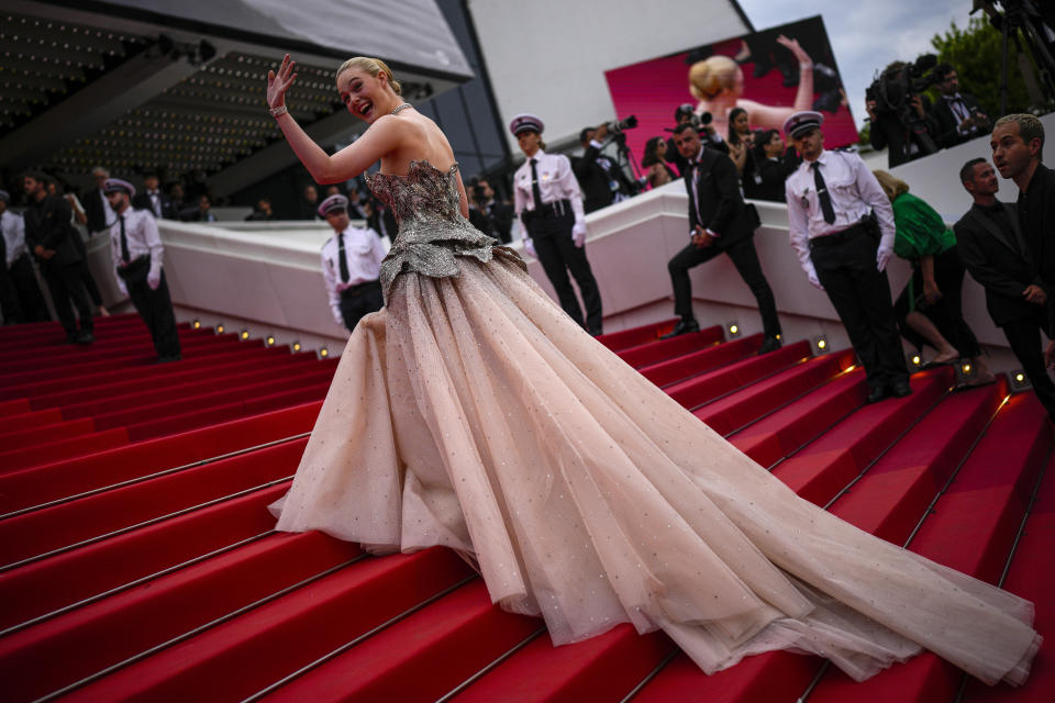 Elle Fanning poses for photographers upon arrival at the opening ceremony and the premiere of the film 'Jeanne du Barry' at the 76th international film festival, Cannes, southern France, Tuesday, May 16, 2023. (AP Photo/Daniel Cole)