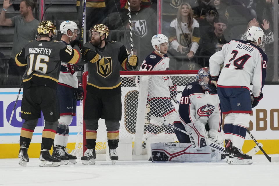 Vegas Golden Knights left wing Pavel Dorofeyev (16) celebrates with right wing Phil Kessel (8) after Kessel scored against the Columbus Blue Jackets during the first period of an NHL hockey game Sunday, March 19, 2023, in Las Vegas. (AP Photo/John Locher)