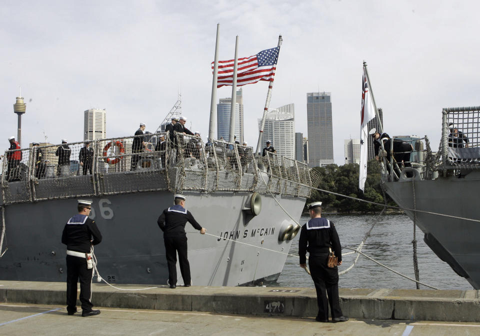 FILE - In this Aug. 20, 2008, file photo, Australian sailors tie up the USS John S McCain (DDG-56) as she arrives in Sydney, Australia for the 100th Anniversary of the Great White Fleet. The U.S. and Australian militaries are joining for an annual anti-submarine exercise focused on ensuring freedom of navigation and the “free flow of commerce in the region.” The 2019 Exercise Sea Dragon starts Monday at Andersen Air Force Base in the western-most U.S. territory of Guam, which is considered a tempting target for China or North Korea in the event of a conflict. (AP Photo/Rob Griffith, File)