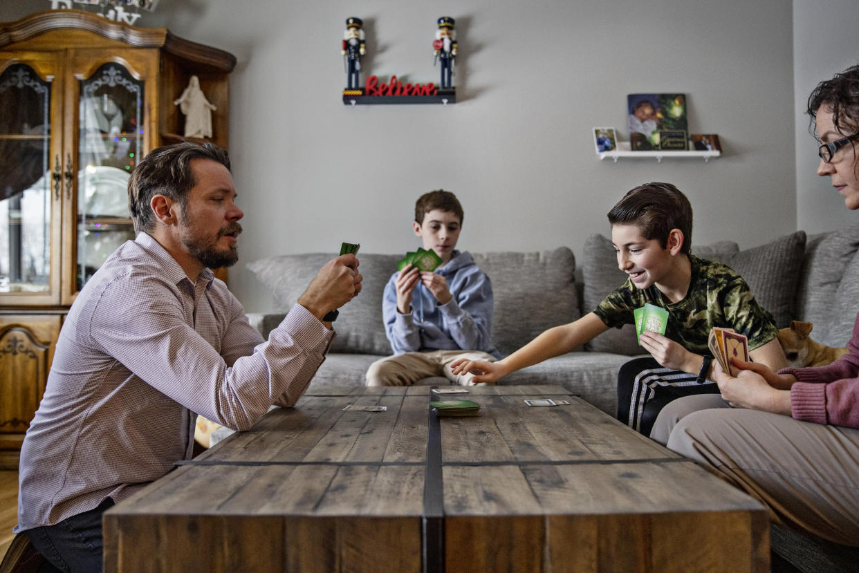 The Johnsons play cards at their home in Woods Cross, Utah. (Kim Raff for NBC News)