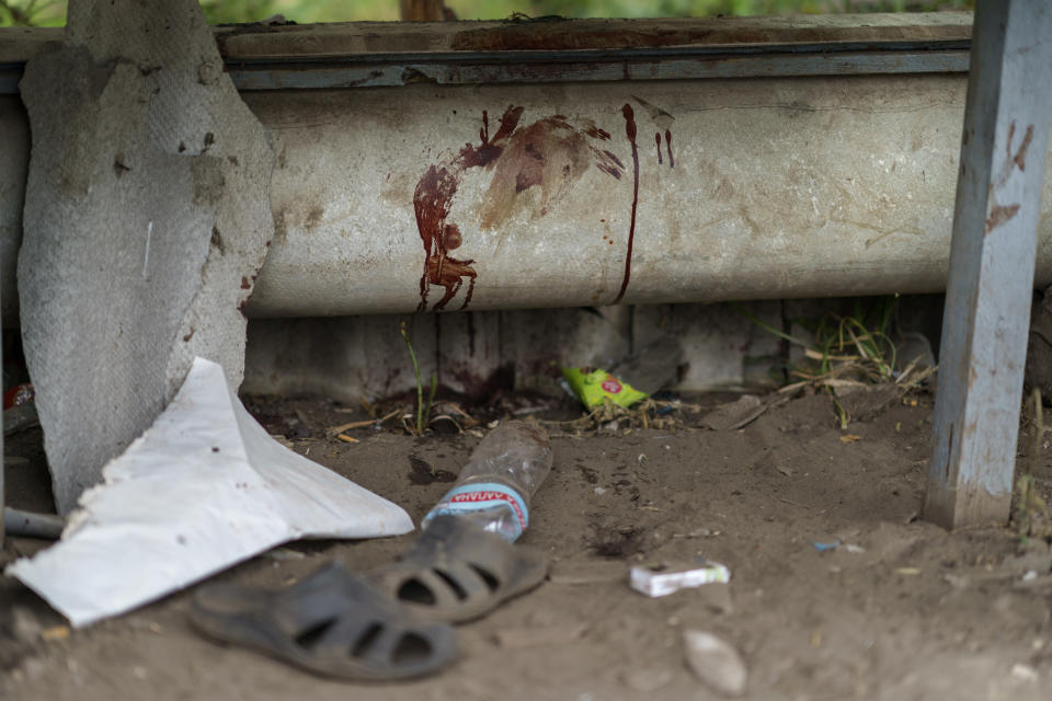 Blood stains a bench where a person was killed in a Russian rocket attack last night in Kramatorsk, Donetsk region, eastern Ukraine, Saturday, Aug. 13, 2022. The strike killed three people and wounded 13 others, according to the mayor. The attack came less than a day after 11 other rockets were fired at the city. (AP Photo/David Goldman)