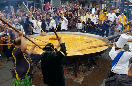 Members of the worldwide fraternity of the omelette prepare a traditional giant omelette made with 10,000 eggs in Malmedy, Belgium August 15, 2017. REUTERS/Christopher Stern