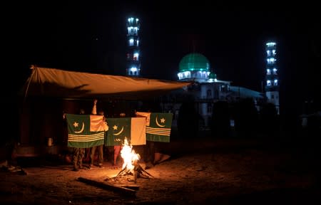 The Wider Image: Barricades and books in restive Kashmir neighbourhood