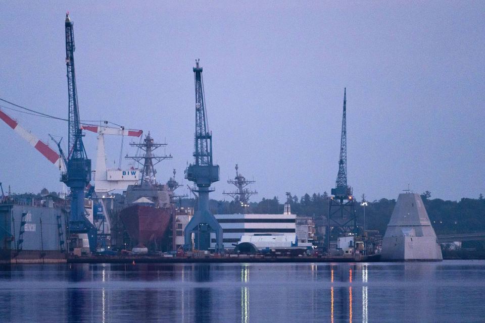 The USS Lyndon B. Johnson, far right, is docked at Bath Iron Works on the Kennebec River, Friday, Aug. 27, 2021, in Bath, Maine. The stealth destroyer is the last of three Zumwalt-class ships built by BIW. (AP Photo/Robert F. Bukaty)