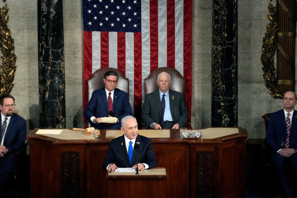 Israeli Prime Minister Benjamin Netanyahu addresses a joint meeting of Congress as Speaker of the House Mike Johnson (R-LA) and U.S. Sen. Ben Cardin (D-MD) listen in the chamber of the House of Representatives at the U.S. Capitol on July 24, 2024 in Washington, DC. Netanyahu’s visit occurs as the Israel-Hamas war reaches nearly ten months. A handful of Senate and House Democrats boycotted the remarks over Israel’s treatment of Palestine.