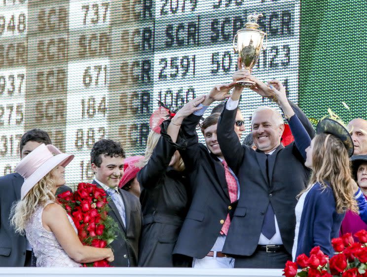 Todd Pletcher hold up the winner's trophy after Always Dreaming #5 won the Kentucky Derby on Saturday. (Getty)