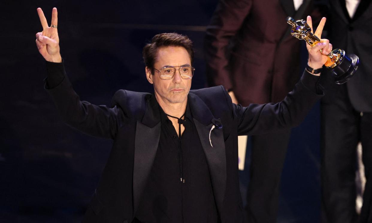 <span>Robert Downey Jr with his supporting actor Oscar. </span><span>Photograph: Mike Blake/Reuters</span>