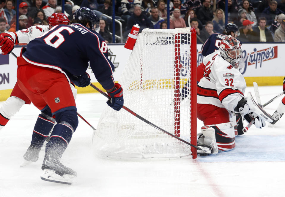 Columbus Blue Jackets forward Kirill Marchenko, left, scores behind Carolina Hurricanes goalie Antti Raanta (32) during the second period of an NHL hockey game in Columbus, Ohio, Saturday, Jan. 7, 2023. (AP Photo/Paul Vernon)