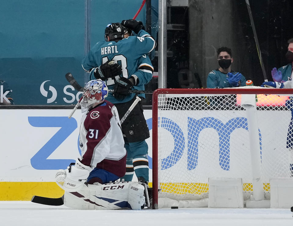 San Jose Sharks center Tomas Hertl (48) hugs a teammates after scoring a goal against Colorado Avalanche goaltender Philipp Grubauer (31) during the second period of an NHL hockey game in San Jose, Calif., on Wednesday, May 5, 2021. (AP Photo/Tony Avelar)