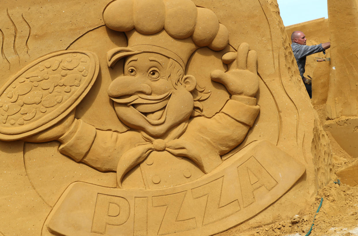 A sand carver works on a sculpture during the Sand Sculpture Festival "Dreams" in Ostend, Belgium June 18, 2019. (Photo: Yves Herman/Reuters)