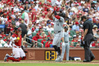 Chicago White Sox's Eloy Jiménez gestures skyward as he crosses home plate after hitting a solo home run during the seventh inning of a baseball game against the St. Louis Cardinals, Sunday, May 5, 2024, in St. Louis. (AP Photo/Scott Kane)