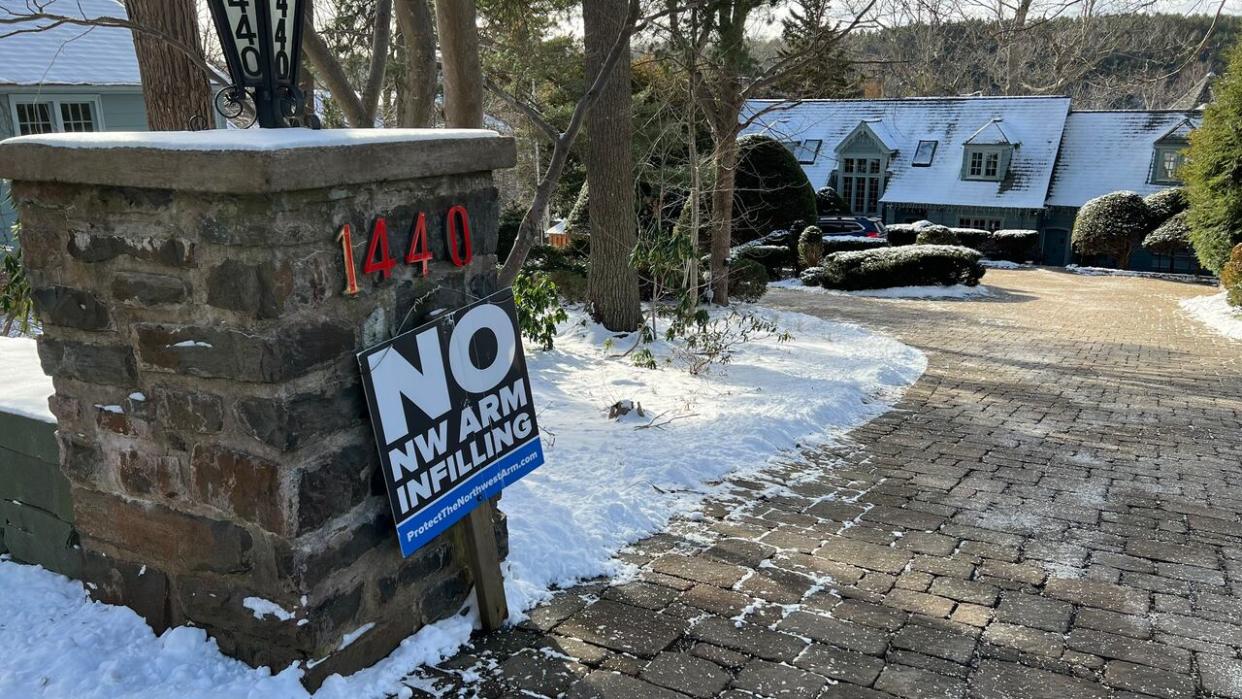 Some residents on Birchdale Avenue have put up signs opposing infilling on the Northwest Arm.  (Paul Poirier/CBC - image credit)