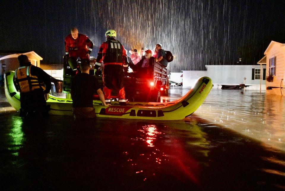 LEOMINSTER - Firefighters use boats to evacuate people and pets from Meadowbrook Acres mobile home park off Central Street late Monday.