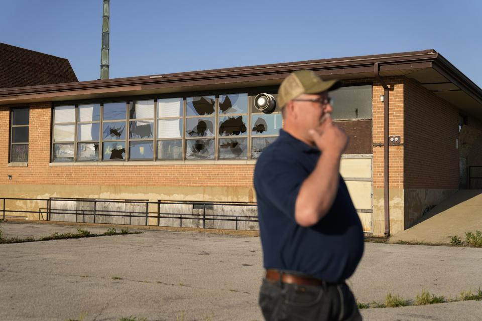 West Alton Mayor Willie Richter speaks outside a vacant and vandalized church Wednesday, May 22, 2024, in West Alton, Mo. Richter recalls the West Alton of decades ago: three churches, an ice cream shop, four taverns where people hung out. "Now we don't have any churches. We have one tavern that's open and it just got reopened not too long ago," he said. (AP Photo/Jeff Roberson)