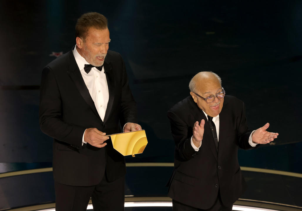 HOLLYWOOD, CALIFORNIA - MARCH 10: (L-R) Arnold Schwarzenegger and Danny DeVito speak onstage during the 96th Annual Academy Awards at Dolby Theatre on March 10, 2024 in Hollywood, California. (Photo by Kevin Winter/Getty Images)