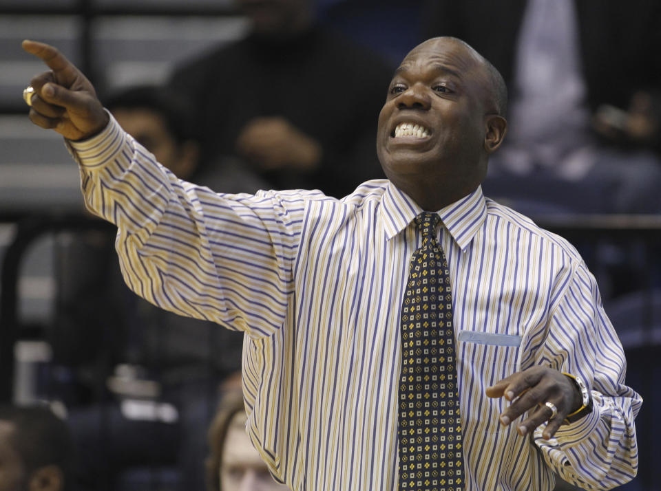 FILE - Then-George Washington head coach Karl Hobbs gestures during the first half of an NCAA basketball game against Temple Saturday, Feb. 26, 2011, in Washington. Hobbs is now an assistant coach at Georgia Tech. Black coaches in the top six men's college basketball leagues are still facing a tough climb in going from assistant to the head job. (AP Photo/Luis M. Alvarez, File)