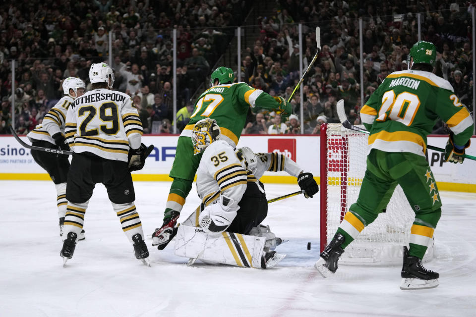 Minnesota Wild left wing Marcus Foligno (17) begins to celebrate his goal on Boston Bruins goaltender Linus Ullmark (35) during the third period of an NHL hockey game Saturday, Dec. 23, 2023, in St. Paul, Minn. (AP Photo/Abbie Parr)