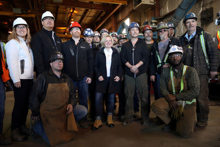 Alberta New Democratic Party (NDP) leader and Premier Rachel Notley poses with workers during a campaign event at Nardei Fabricators in Calgary, Alberta, Canada, April 15, 2019. REUTERS/Chris Wattie