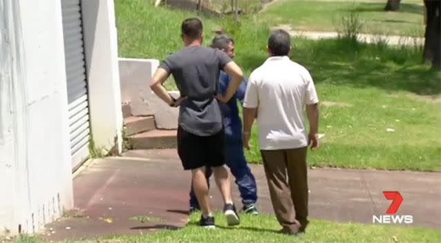 Victim Riad Awad (blue suit) returns home after speaking with police. Source: 7 News