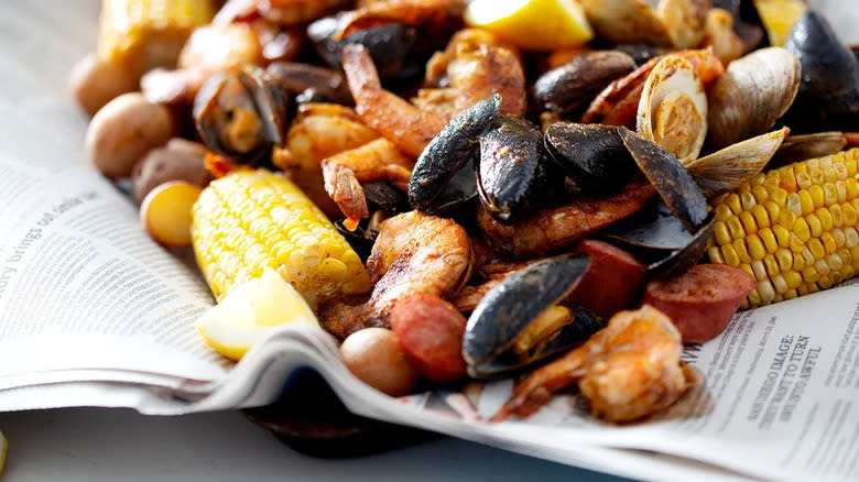 Mussels, clams, and shrimp boil on newspaper