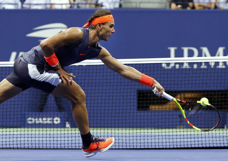 Rafael Nadal, of Spain, reaches to hit a backhand to Dominic Thiem, of Austria, during the quarterfinals of the U.S. Open tennis tournament, Tuesday, Sept. 4, 2018, in New York. (AP Photo/Jason DeCrow)