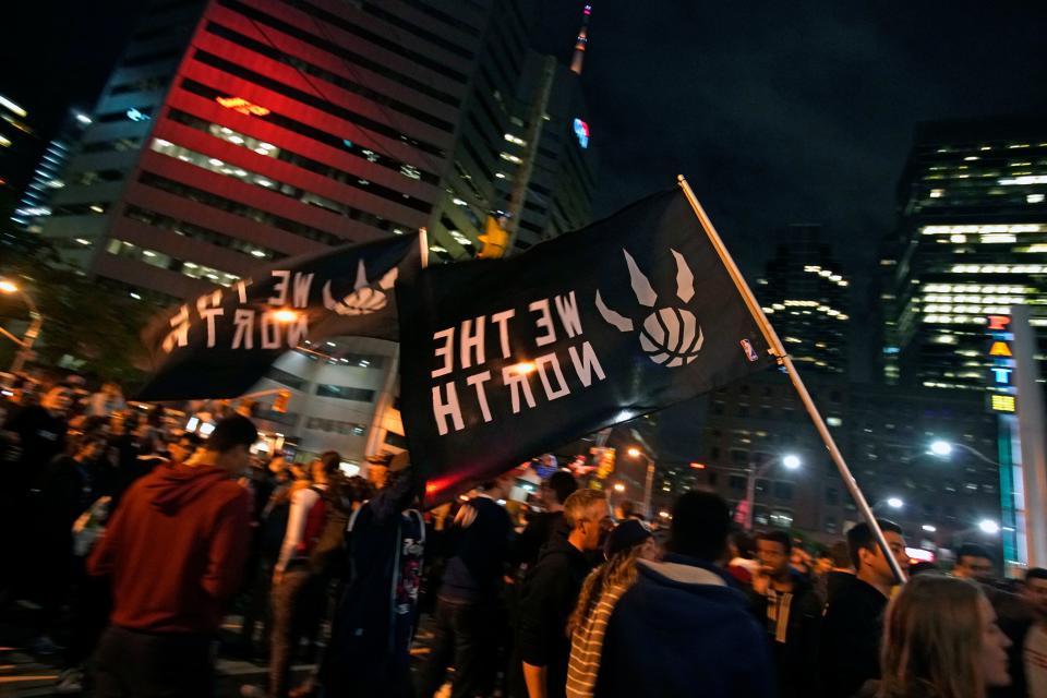 Toronto Raptors fans celebrate their win in the NBA championships in downtown Toronto, Ontario on early June 14, 2019. (Photo by Geoff Robins / AFP) (Photo credit should read GEOFF ROBINS/AFP/Getty Images)