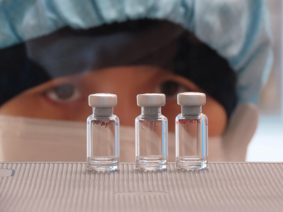 A scientist checks quality control of vaccine vials for correct volume at the Clinical Biomanufacturing Facility (CBF) in Oxford, Britain, April 2, 2020. (Sean Elias via Reuters)