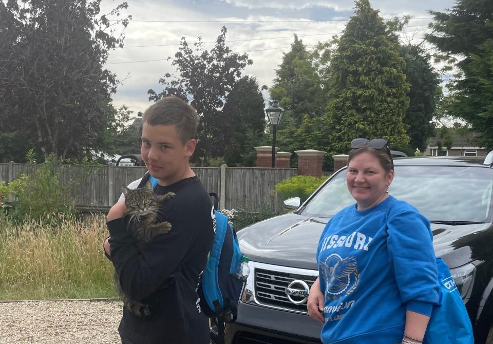 War refugees Vlad, 14, and his mother, Vitalina, reunite with their cat, Zephyrka (Ukrainian for marshmallow), at Laura Potts' home in England in 2022. The three fled Ukraine together in March, then Zephyrka had to spend two months in quarantine in Holland.