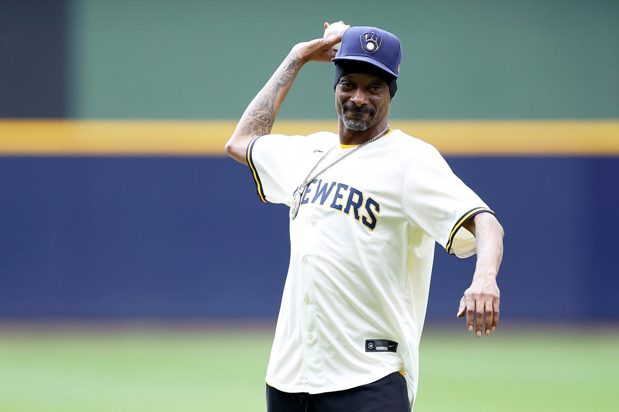 MILWAUKEE, WISCONSIN - JUNE 15: Rapper and producer Snoop Dogg throws out the first pitch before the game between the Milwaukee Brewers vs Cincinnati Reds at American Family Field on June 15, 2024 in Milwaukee, Wisconsin. (Photo by John Fisher/Getty Images)