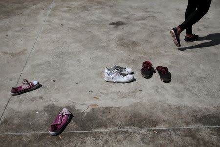 Shoes of Cuban migrants are seen at the Costa Rican border with Nicaragua, November 18, 2015. REUTERS/Oswaldo Rivas