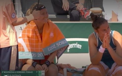 Marie Bouzkova and Sara Sorribes Tormo are seen laughing as their opponents are disqualified - French Open controversy after doubles pair disqualified for hitting ball girl
