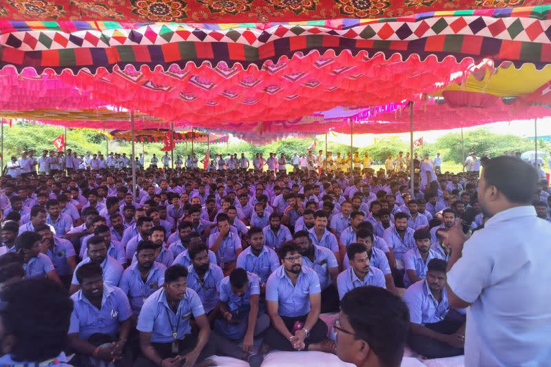 Workers of a Samsung facility listen to a speaker during a strike to demand higher wages at its Sriperumbudur plant