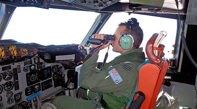 A Royal Australian Air Force pilot of an AP-3C Orion maritime patrol aircraft scans the surface of the sea near the west of Peninsula Malaysia. Reuters.