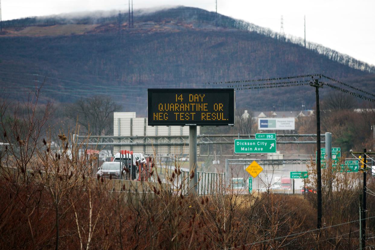 A sign on Interstate 81 in Scranton, Pennsylvania, on Monday, November 30, 2020, informs drivers of the state's travel order that people visiting or returning to the state have a negative COVID-19 test quarantine for 14 days.