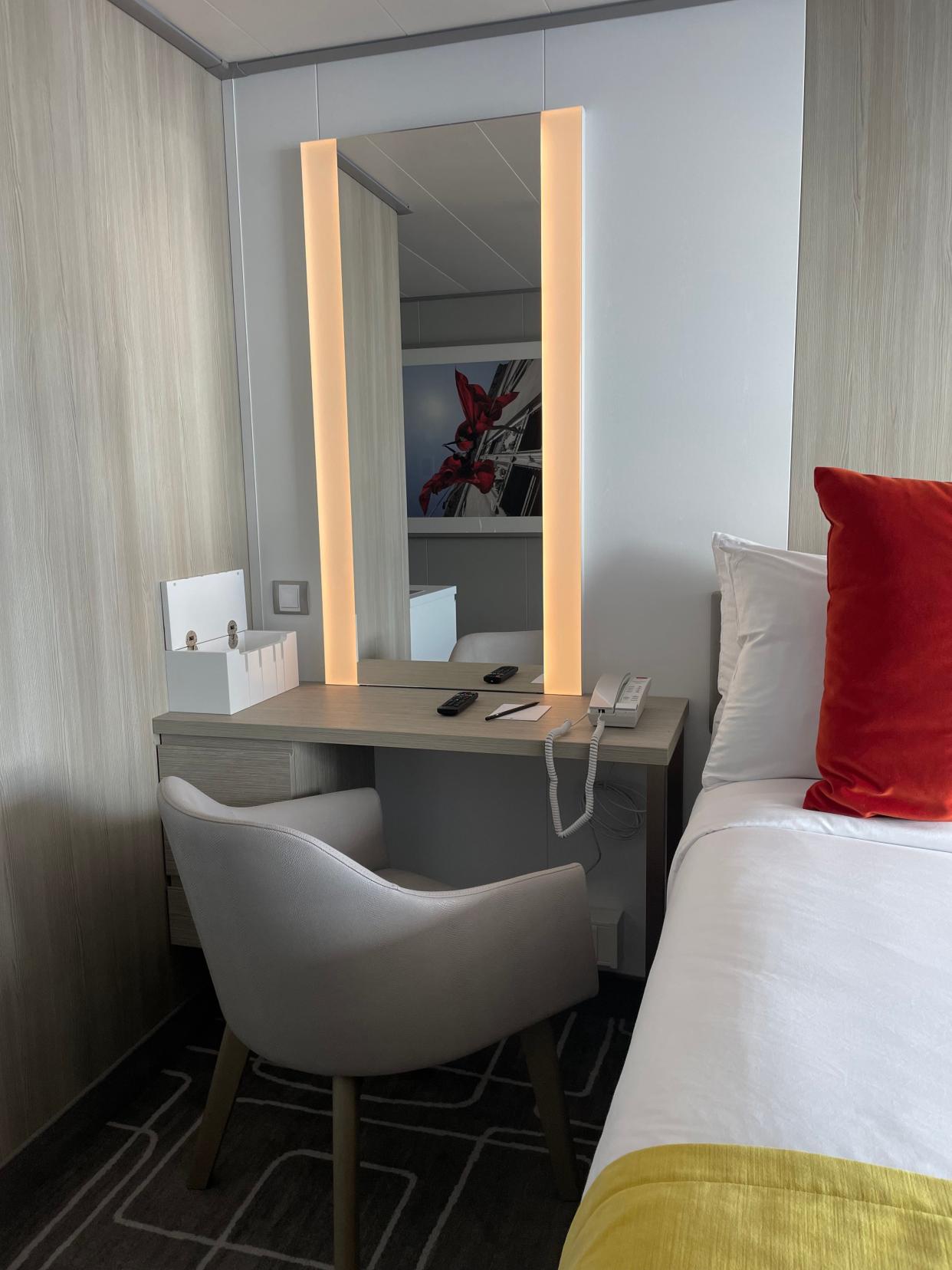 The stateroom has a desk area with a phone.