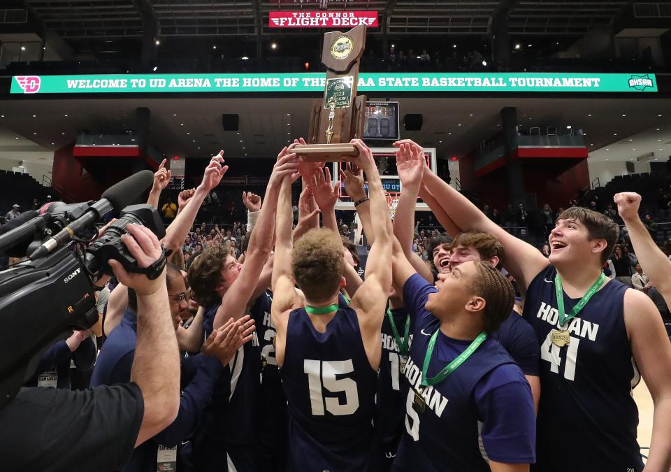 The Hoban Knights hold up the OHSAA Division I state championship trophy, Sunday, March 19, 2023, in Dayton.