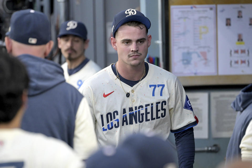 Los Angeles Dodgers starting pitcher River Ryan walks through the dugout as he leaves a baseball game with an injury during the fifth inning against the Pittsburgh Pirates, Saturday, Aug. 10, 2024, in Los Angeles. (AP Photo/Jayne-Kamin-Oncea)