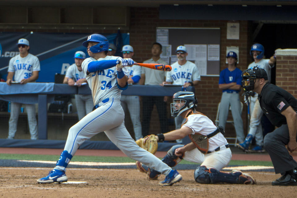 Duke's Luke Storm hits an RBI single in the eighth inning during an NCAA college baseball super regional game against Virginia, Friday, June 9, 2023 in Charlottesville, Va. (AP Photo/John C. Clark)