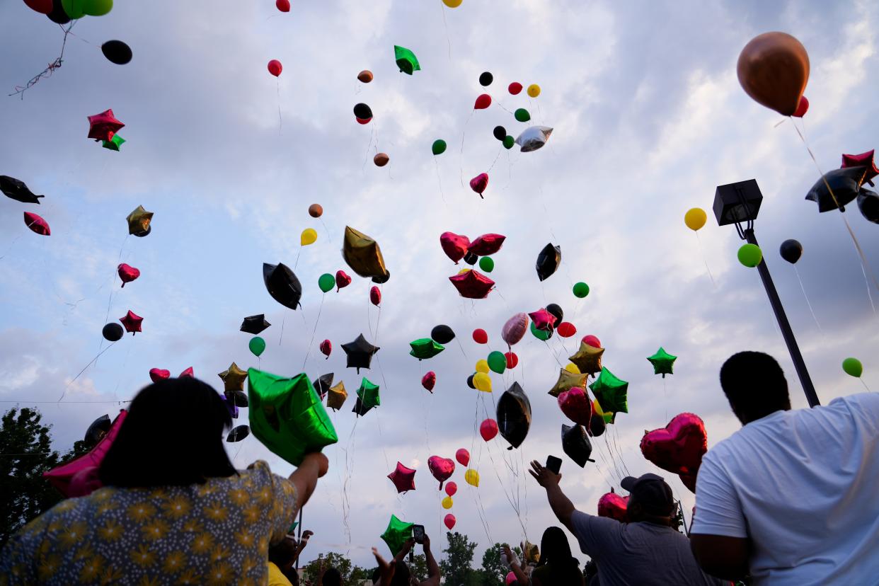 Friends and family of Don "Irie" Williams release balloons from the Glenway Crossing Transit Center in Westwood on Wednesday to mark his death. Williams was hit and killed by a Metro bus on Tuesday.