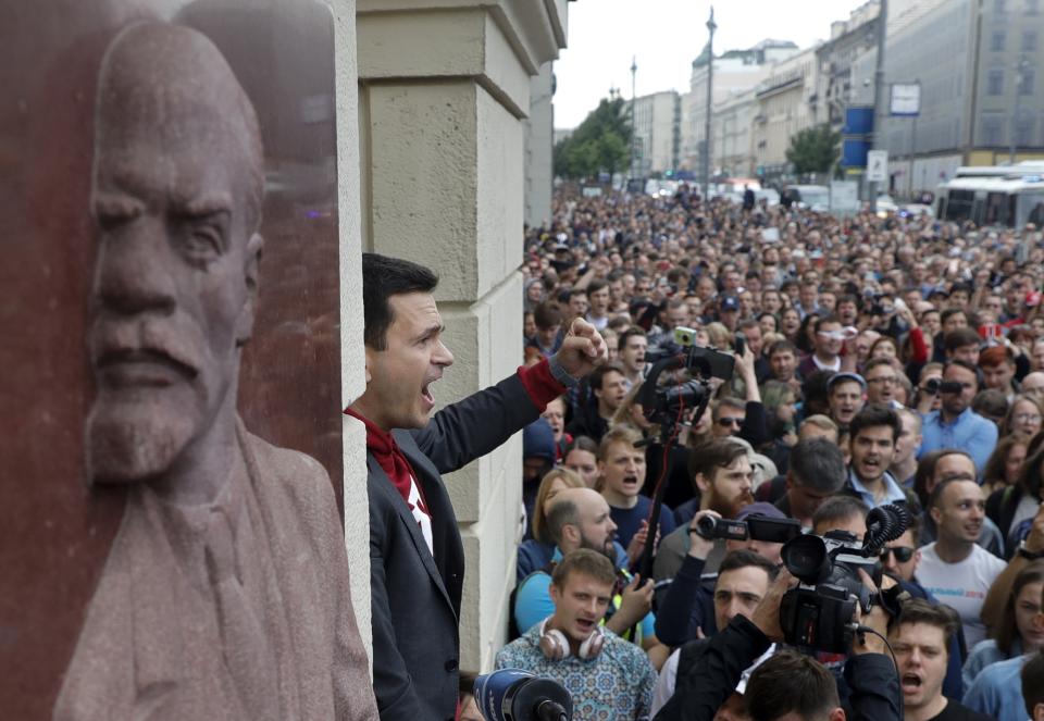 FILE - Russian opposition candidate and activist Ilya Yashin, center, gestures while speaking to a crowd next to a bas-relief of the Soviet founder Vladimir Lenin, left, during a protest in Moscow, Russia, on July 14, 2019. Yashin, 39, is one of the few prominent opposition figures that refused to leave Russia despite the unprecedented pressure the authorities have mounted on dissent in recent years. A sharp critic of the Kremlin, a vocal ally of imprisoned opposition leader Alexei Navalny and an uncompromising member of a Moscow municipal council, Yashin was arrested in June. (AP Photo/Pavel Golovkin, File)